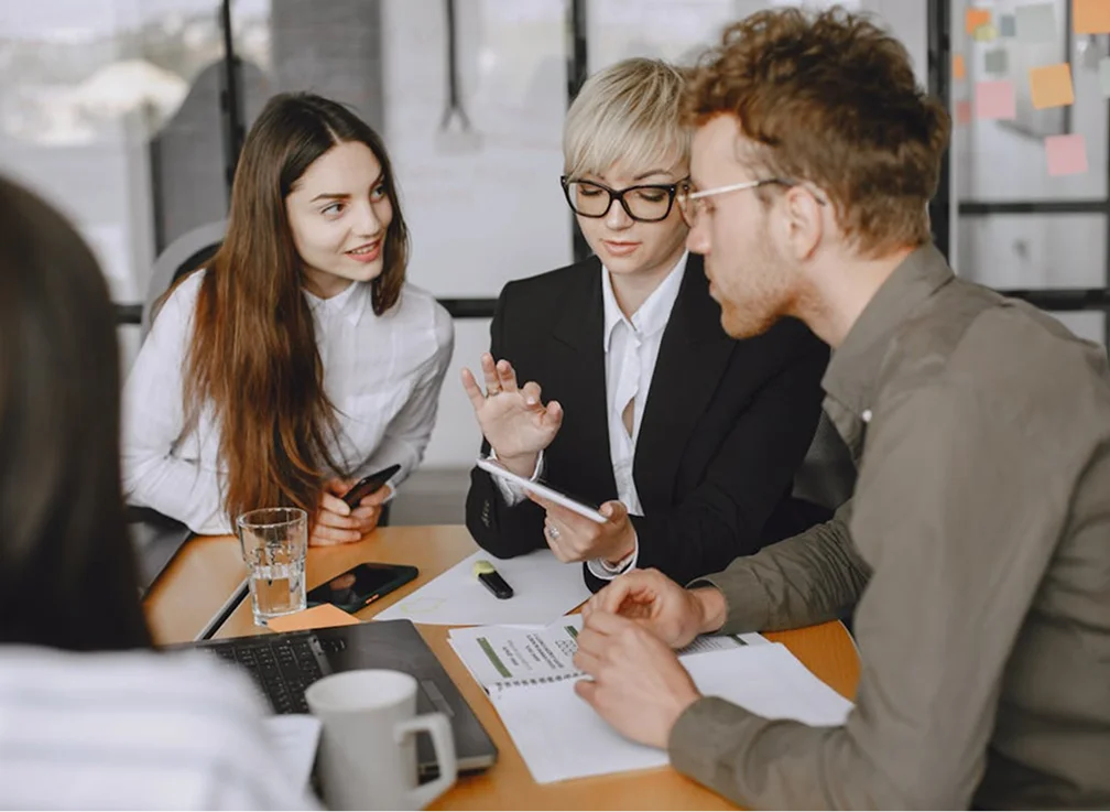 A group of three professionals in a meeting