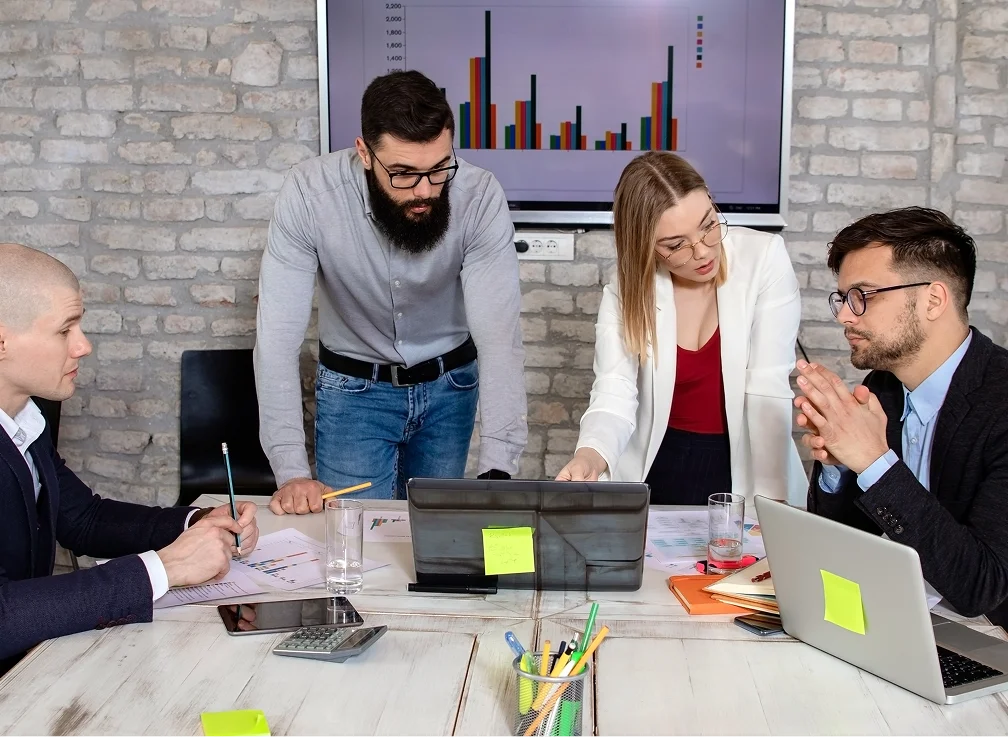A group of four professionals in a meeting