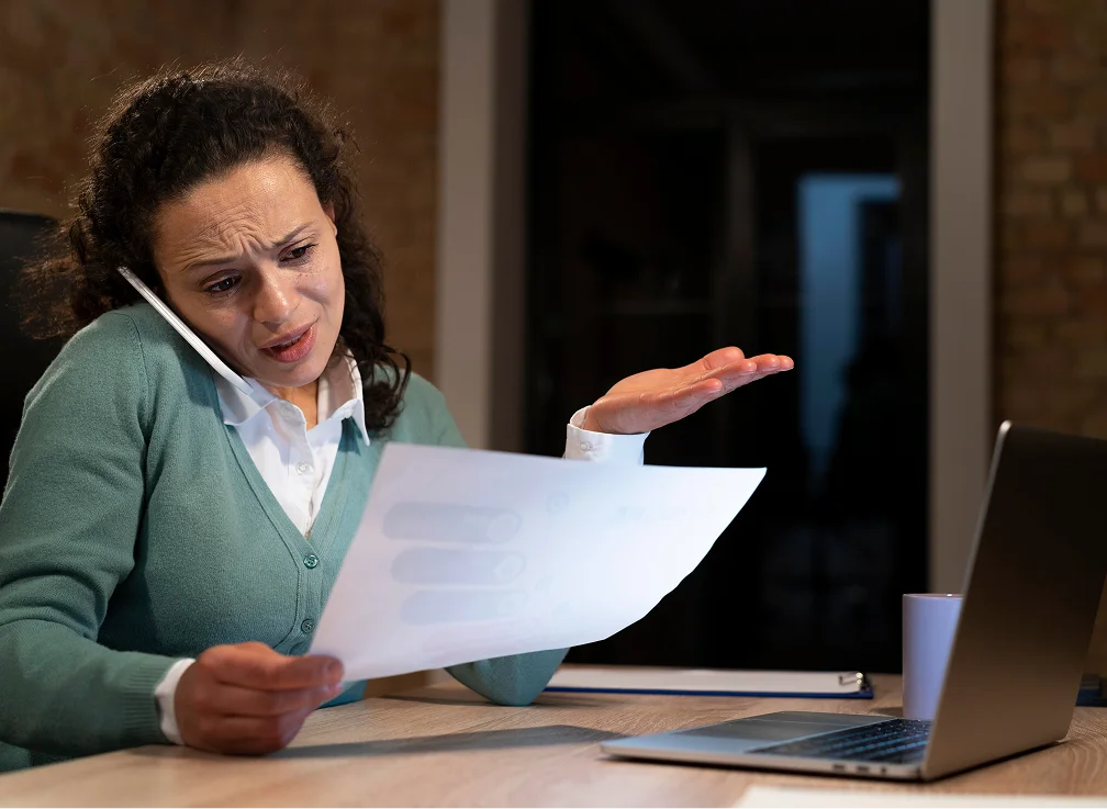 A woman sitting at a desk with a laptop